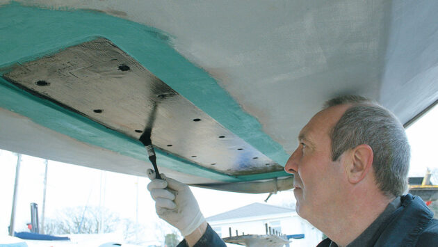 A man painting a keel receess