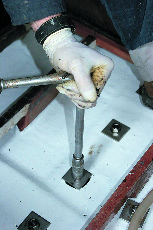 Keel bolts being tightened inside a yacht