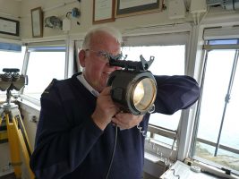 A watchkeep with the NCI used an Aldis lamp to signal Morse Code to a yacht in danger