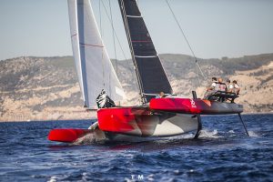 A red foiling trimaran