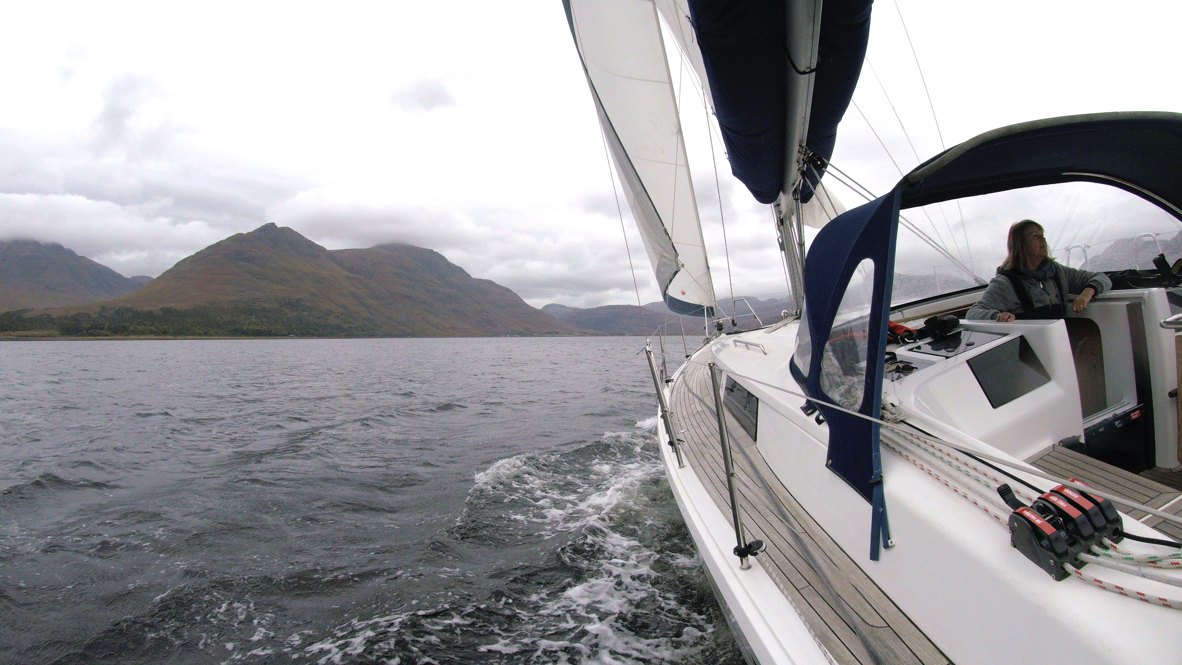 A yacht sailing in a loch in Torridon, Scotland