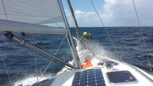 A member of crew on the deck of a yacht crossing the Atlantic