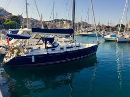 A blue yacht in a marina
