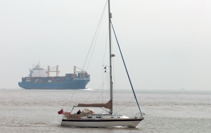 A yacht sailing in a shipping lane