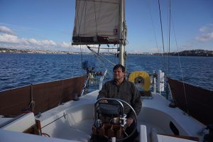 A man helming a yacht