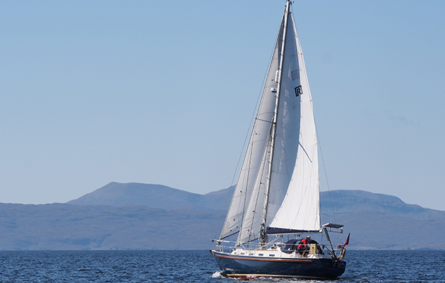 A yacht with a white sail