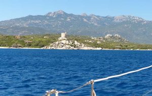 yacht in blue waters of Baie de Figari, Corsica