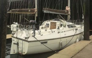 A white yacht with re-stepped masts