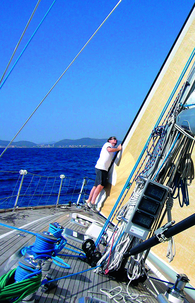 A man holding sails on a yacht