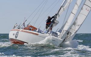 Golden globe Race skipper Peche adjusts sails on his Rustler 36