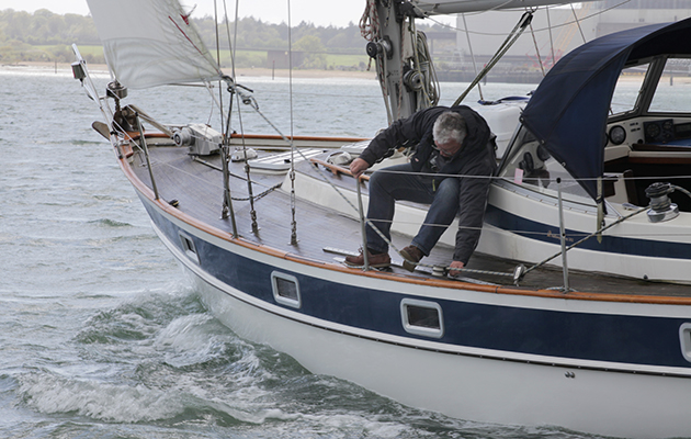 A sailor sets up the genoa car