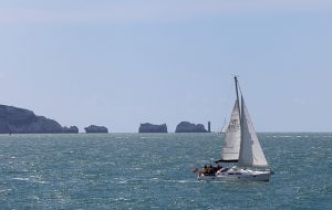 A yacht heading past the Needles on its way to cross the Channel