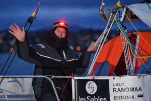 Uku Randmaa in wet weather gear and a head torch leaving Hobart