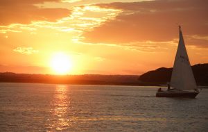 A yacht cruising as the sun sets on a English winter day