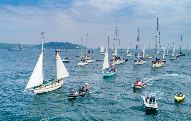 Suhaili is greeted by HMS Mersey as she returns to Falmouth, 50 years after Robin Knox Johnston's solo non stop circumnavigation. Photo: Clipper/Shaun Roster