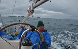 Jonty Pearce at the helm while sailing in Scotland