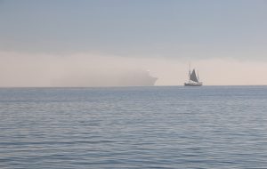 A yacht sailing into fog