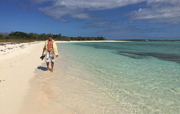 Andy Gibb walking across the beach