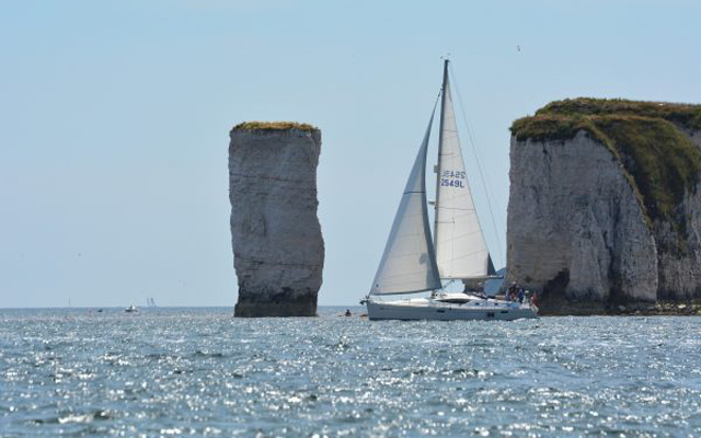 A yacht sailing in Studland Bay