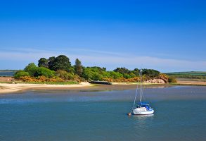 A yacht anchored in poole harbour in the summer