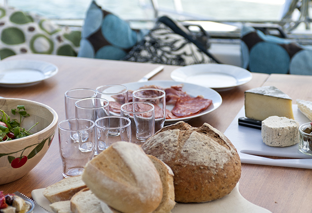 Food laid out on a table on the deck of a yacht