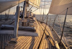 a teak deck under a sunrise