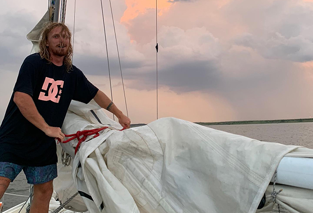 Elliott Smith bringing in sails on his boat