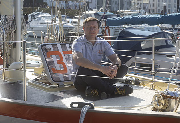 A man sitting on the deck of a boat