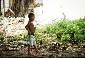 A child standing amongst plastic rubbish in the San Blas isands