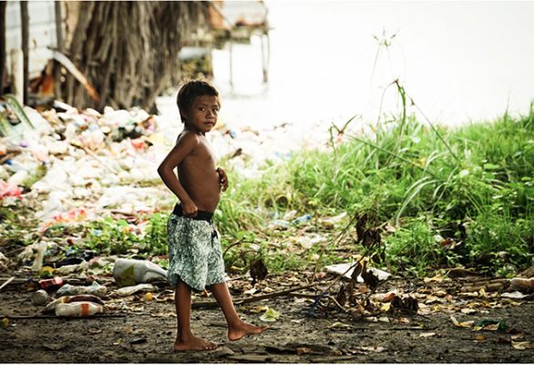A child standing amongst plastic rubbish in the San Blas isands