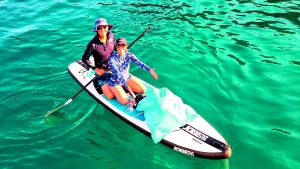 Nicholas and Catherine Hodgson have been collecting rubbish for the last five years, and find a SUP is the best way to transport trash to their boat. Credit: Nicholas Hodgson