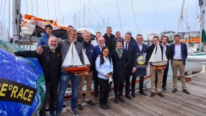 Some of the 23 skippers who are planning on taking part in the 2022 golden Globe Race standing on a pontoon in Les Sables d'Olonne