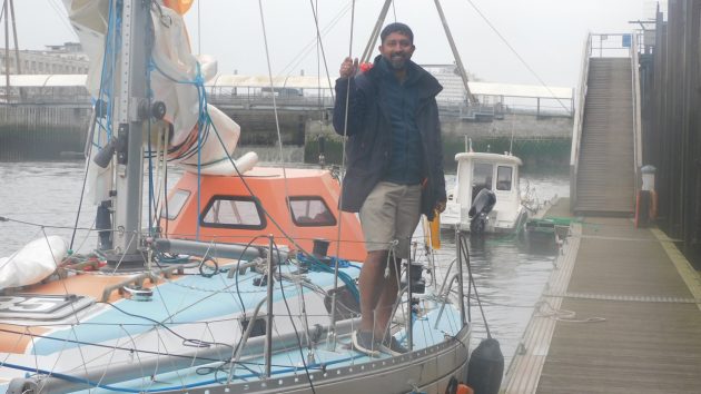 Indian solo sailor Abhilash Tomy standing on the deck of his boat ahead of the 2022 Golden Globe Race
