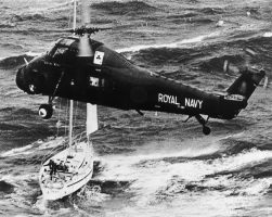 A helicopter hovering over a damage yacht from the 1979 Fastnet Race