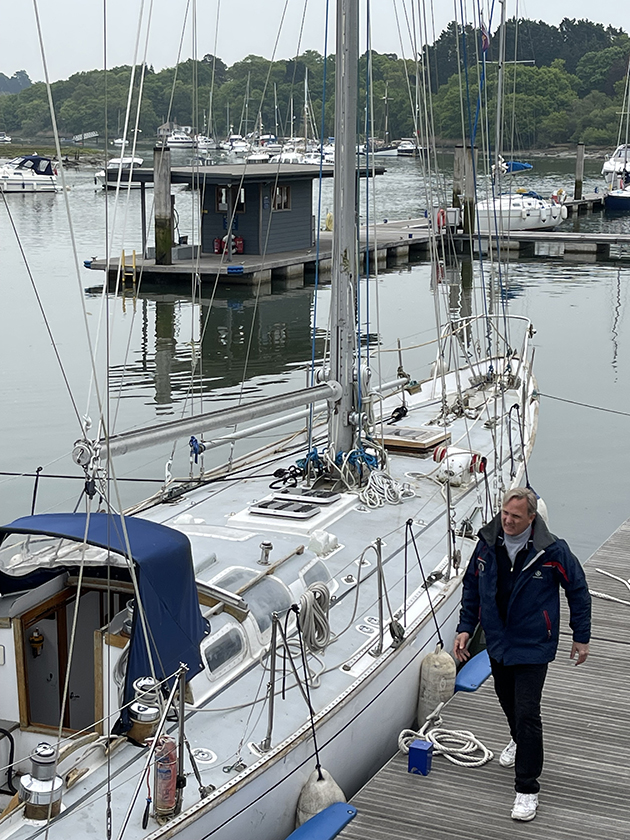 A man walking pass Gipsy Moth IV