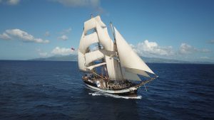 Pelican of London tall ship under full sail out in the ocean