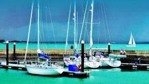 Yachts moored under dark skies