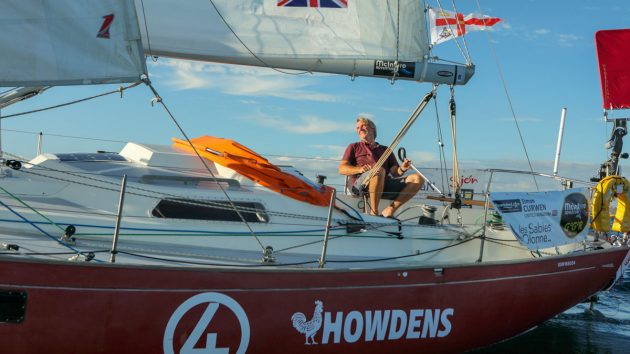 A sailor sailing his boat in wind