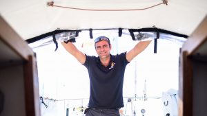 Damien Guillou in the companionway of his boat