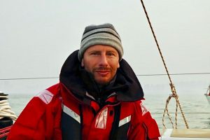 Ian Herbert-Jones wearing a hat while sailing