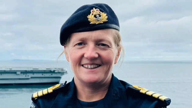 Captain Claire Thompson OBE smiling in a navy beret