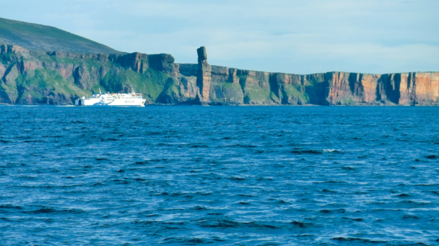 The Scrabster ferry looking small under the towering gaze of the Old Man of Hoy 