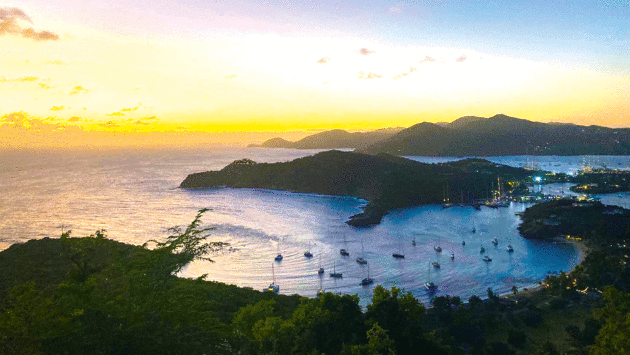 The view from Shirley Heights in Antigua – looking down at our boat Zoe on anchor in Freeman’s Bay, with Nelson’s Dockyard beyond 