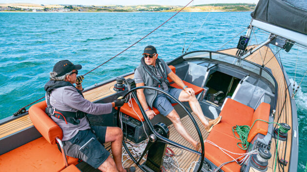 Someone at the helm in a cap