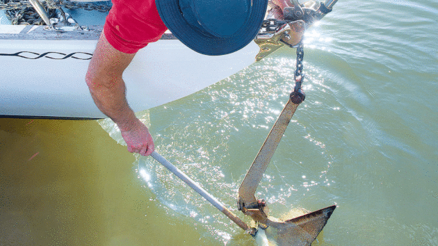 Brushing mud off an anchor