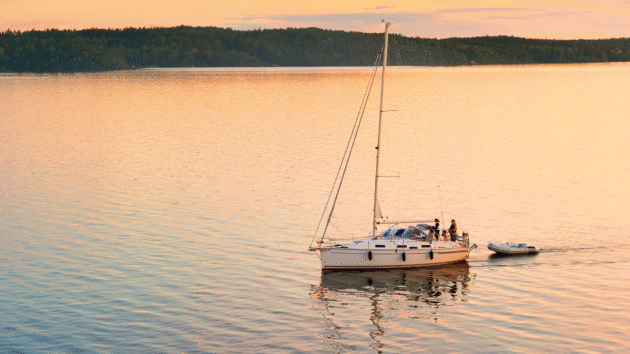 Yacht on calm water during a sunset