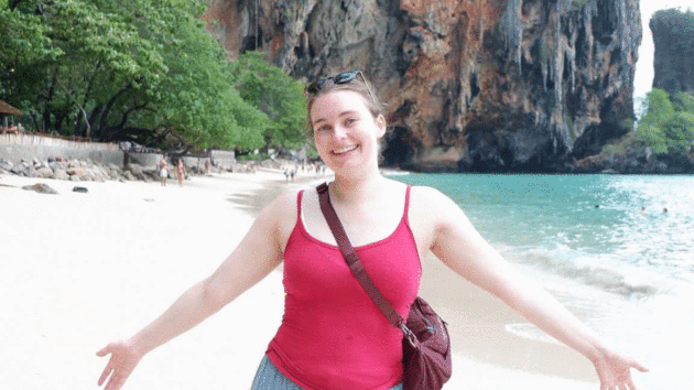 Jenny smiling on a beach