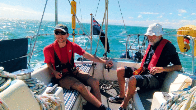 Two people in the sun on a yacht