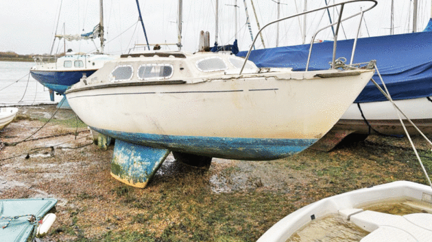 abandoned bilge-keeled yacht
