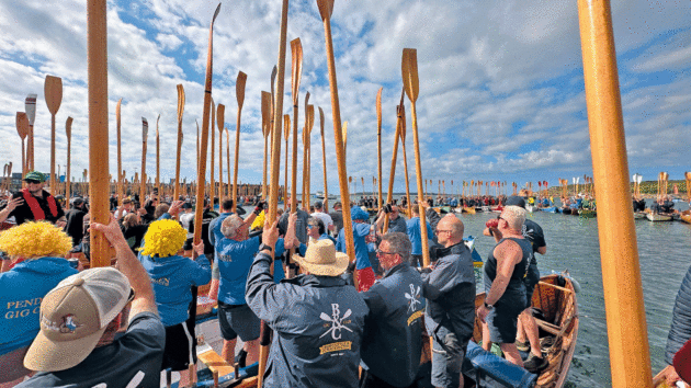 A pagan forest of oars greet the world champions after the final race.